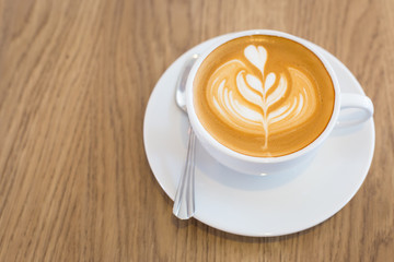 Hot art Latte Coffee in a cup on wooden table