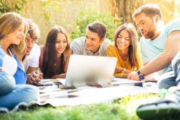 Students using laptop outdoors