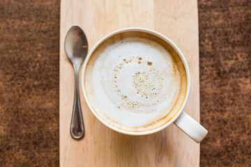 hot latte art coffee  on wooden table, vintage and retro style.