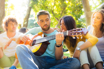 Friends with guitar having fun