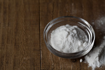 Baking soda, Sodium bicarbonate in glass bowl on wooden table