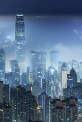 Misty night view of Victoria harbor in Hong Kong city