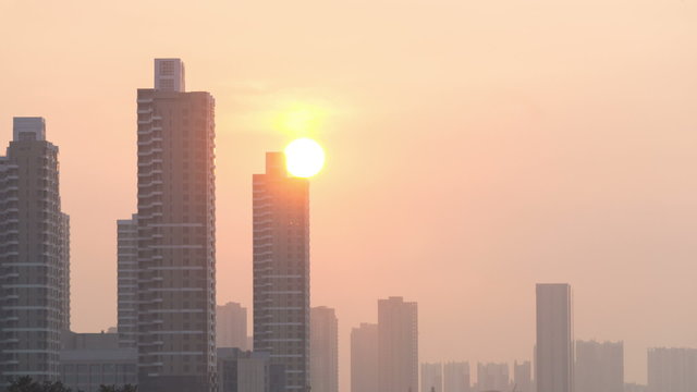 Timelapse of sunset behind the buildings