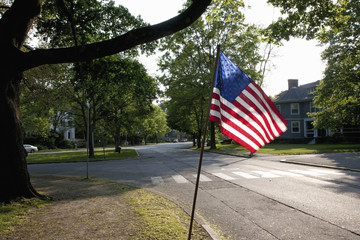 American Flag flies over empty suburban streets of historic Lexington, MA on Memorial Day, 2011