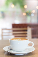 Hot art Latte Coffee in a cup on wooden table
