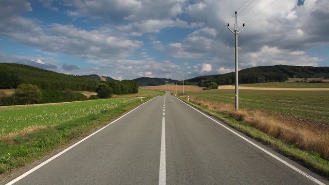 On the empty road between field