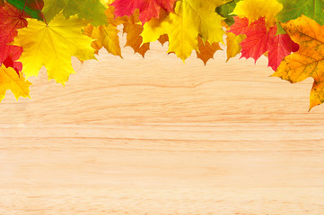 Naklejka na ściany i meble Autumn maple leaves over wood texture close-up