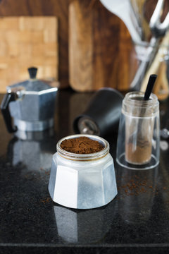 Traditional italian moka  coffee pot filled with fresh ground coffee. Selective focus.