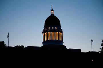Historic Maine State Capitol Building at dusk with deep blue sky, Augusta, Maine, the state capital.