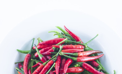 Red and green chilli on white dish