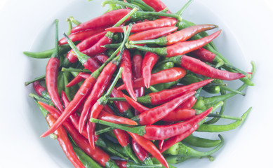 Red and green chilli on white dish