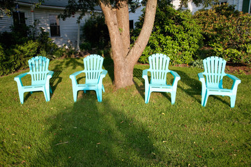 Turquois lawn chairs in sunset light, near Maine & New Hampshire border.