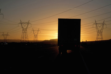 Truck into setting sun on Interstate 15 in California.