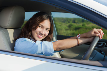 asian woman happy when her drive a new car