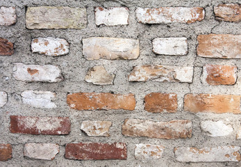 Red brick background: closeup of an old uneven brick wall.
