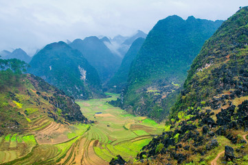 Naklejka na ściany i meble Green valley in Ha Giang, Vietnam. Ha Giang is a province in northeastern Vietnam. It is located in the far north of the country, and contains Vietnam's northernmost point.
