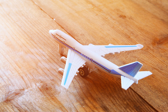toy airplane over wooden textured table. retro style image
