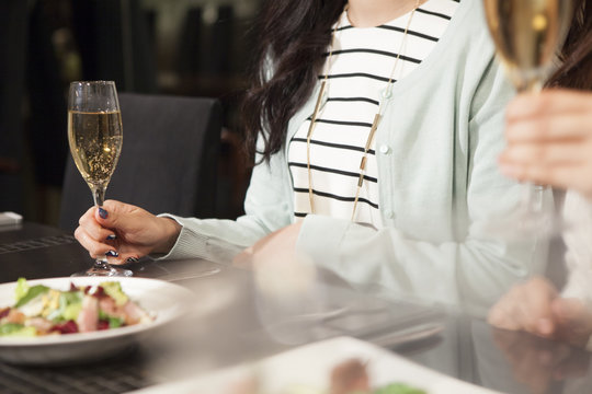 Women have a meal while watching the champagne