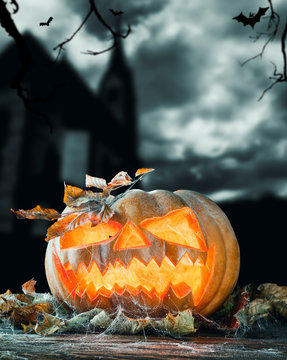 Halloween pumpkin with church on background