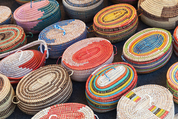 Colorful African wicker baskets in a row - obrazy, fototapety, plakaty