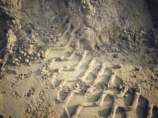 Wheel tracks on the soil.