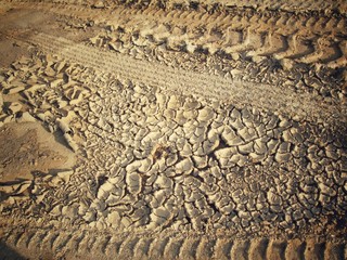 Wheel tracks on the soil.