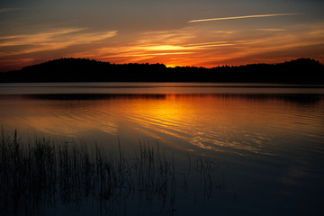 Quiet landscape with a lake at sunset.