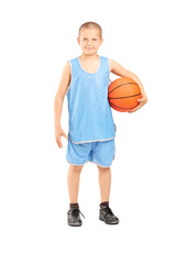 Little boy in a blue jersey holding a basketball