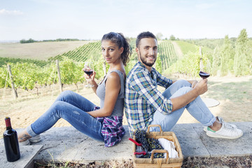 young couple toasting in a vineyard