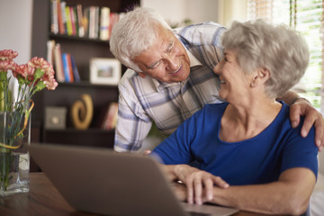Senior marriage spending time in front of computer