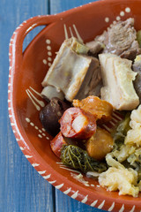 typical portuguese dish on ceramic plate on bue wooden background