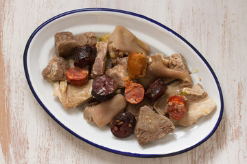 typical portuguese dish on plate on white wooden background
