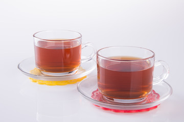 Tea in glass cup or glass cup of black tea on a background.