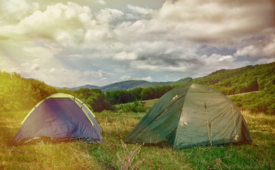 Two tents in the woods in the morning.