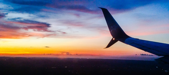 Airplane tail in colorful sunset sky