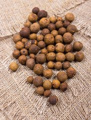 Grains of allspice on a canvas