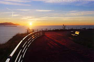 Benches in La Galea park in Getxo at sunset