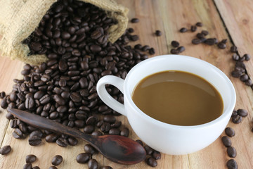 White coffee cup and roasted coffee beans.
