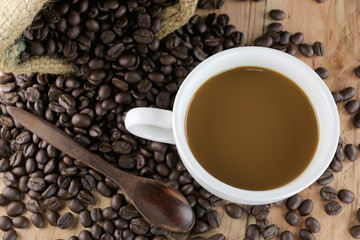 White coffee cup and roasted coffee beans.