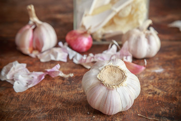 Garlic and onion organic herbs and spices on wooden background