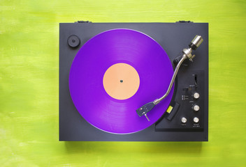 Retro turntable with purple vinyl record, free copy space