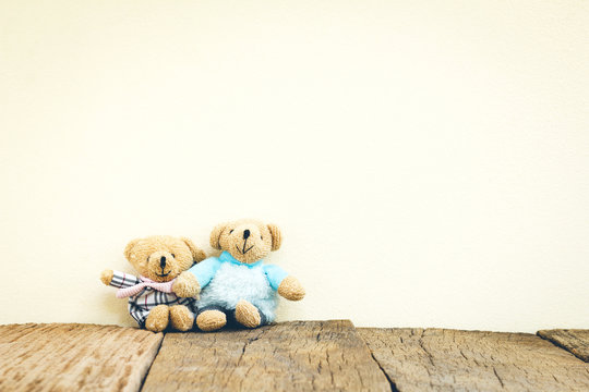 Teddy Bears toy on wood in front concrete background