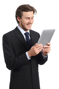 Happy young business man reading a tablet reader
