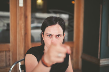 Woman pointing with angry expression