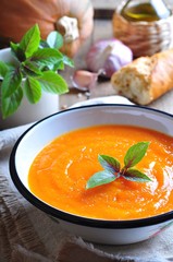 Vegetarian pumpkin soup with garlic, basil and olive oil