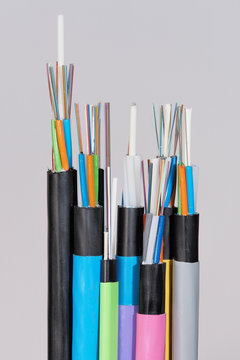 Group Of 7 Different Fiber Optic Cable  Ends With Stripped Jacket Layers And Exposed Colored Fibers, Straight View, Melbourne 2015