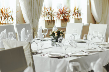 White napkin nicely folded on the plates, serving a celebratory banquet