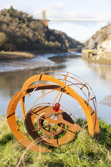 Navigation marker on the River Avon estuary at Bristol, with the Clifton Suspension Bridge in the distance.