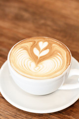Cup of coffee latte art on wood table