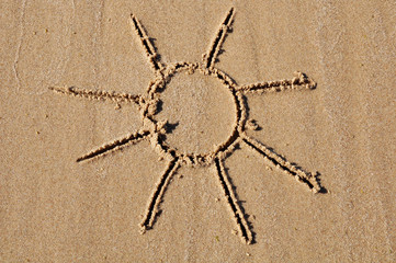 sun drawing on beach sand